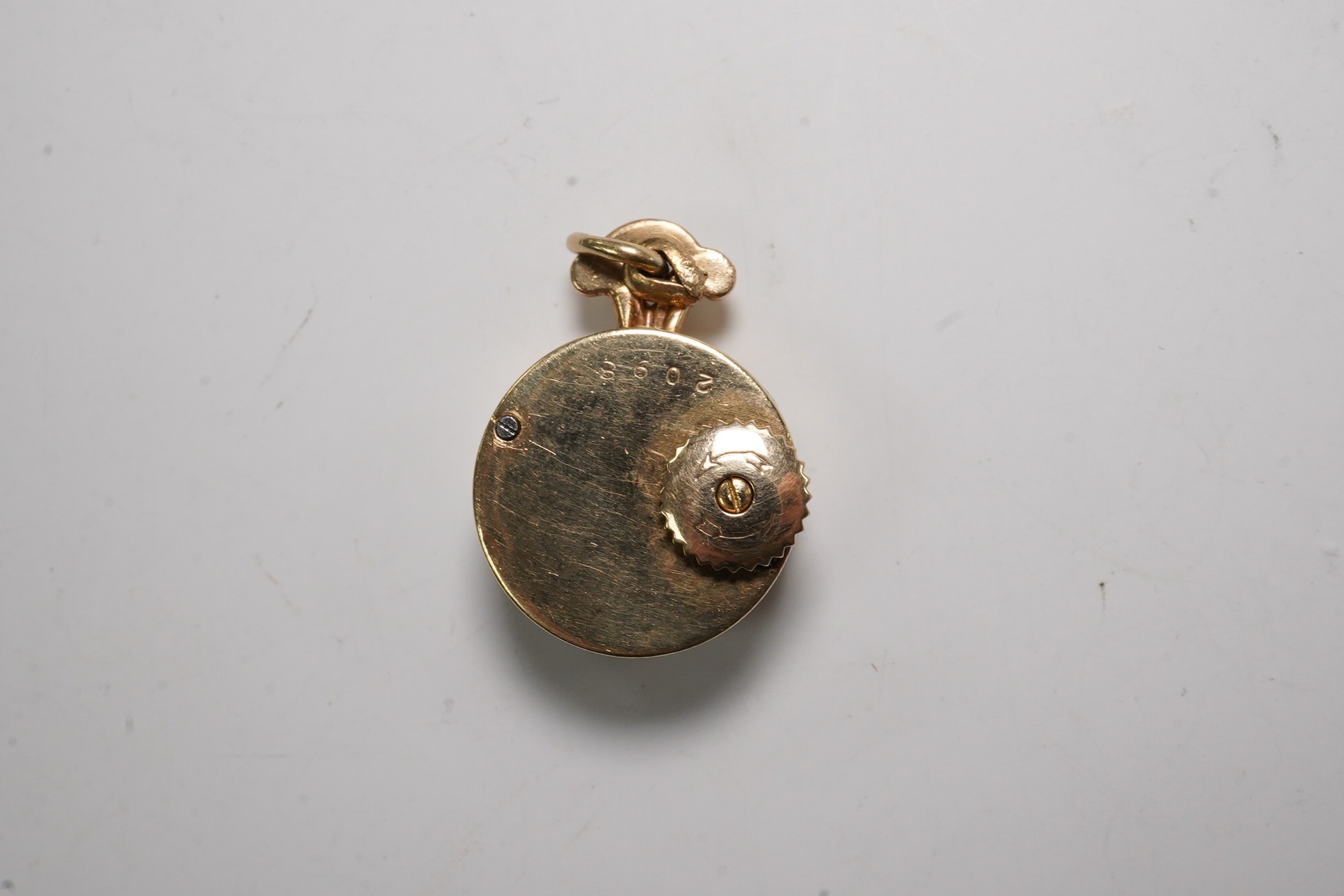 A lady's 9ct Jaeger LeCoultre manual back wind pendant watch, case diameter 15mm, gross weight 7.1 grams. Condition - fair